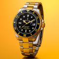 Rolex Submariner watch with gold and silver band on a yellow background