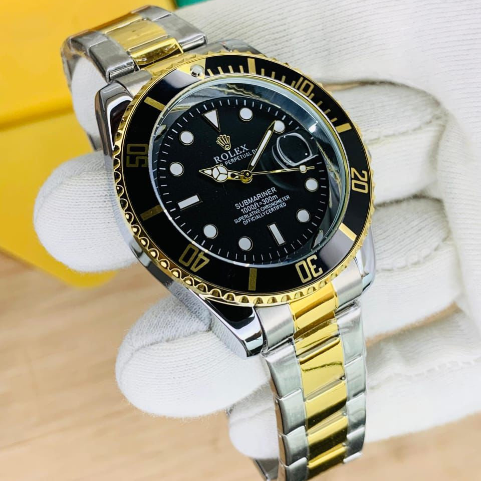 Luxury watch with black dial and gold accents on a white stand