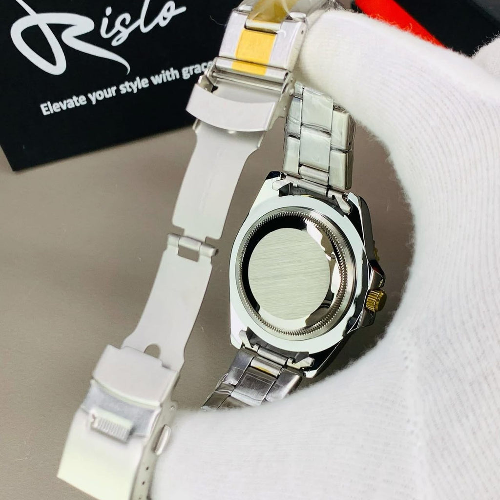 Silver watch with white band on a white surface, Risto brand visible